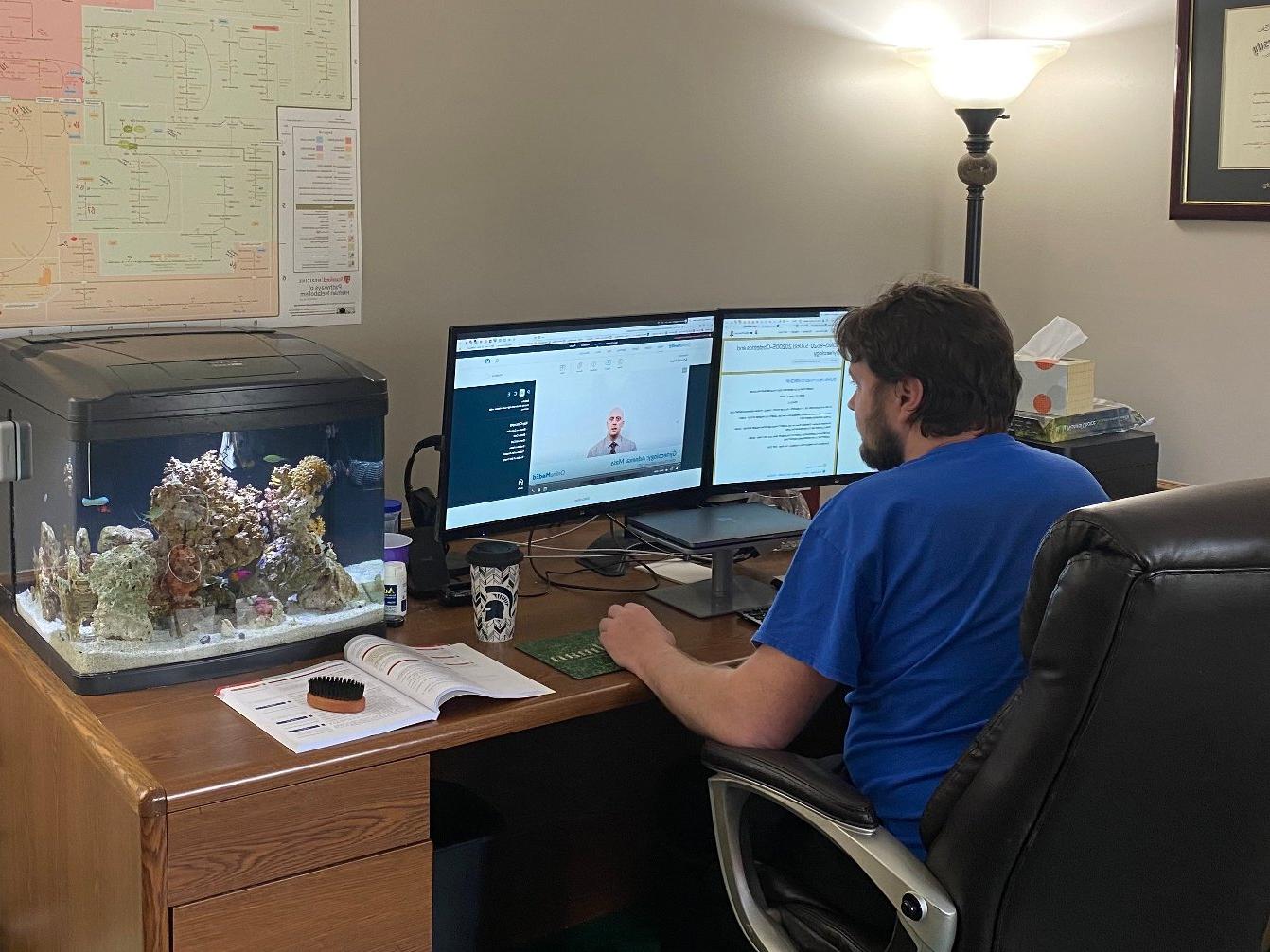 An OUWB student studies in his home office.