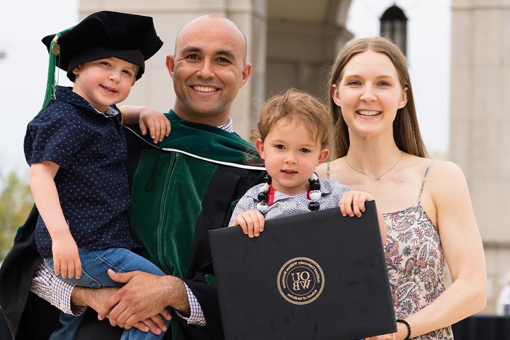 An image of an OUWB graduate and his family